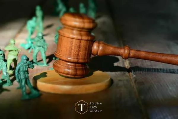 a gavel and military models on a desk